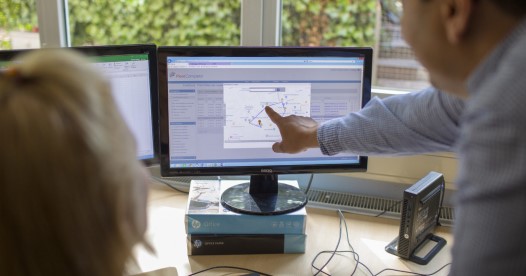 Man pointing at Fleet Complete platform on a computer screen